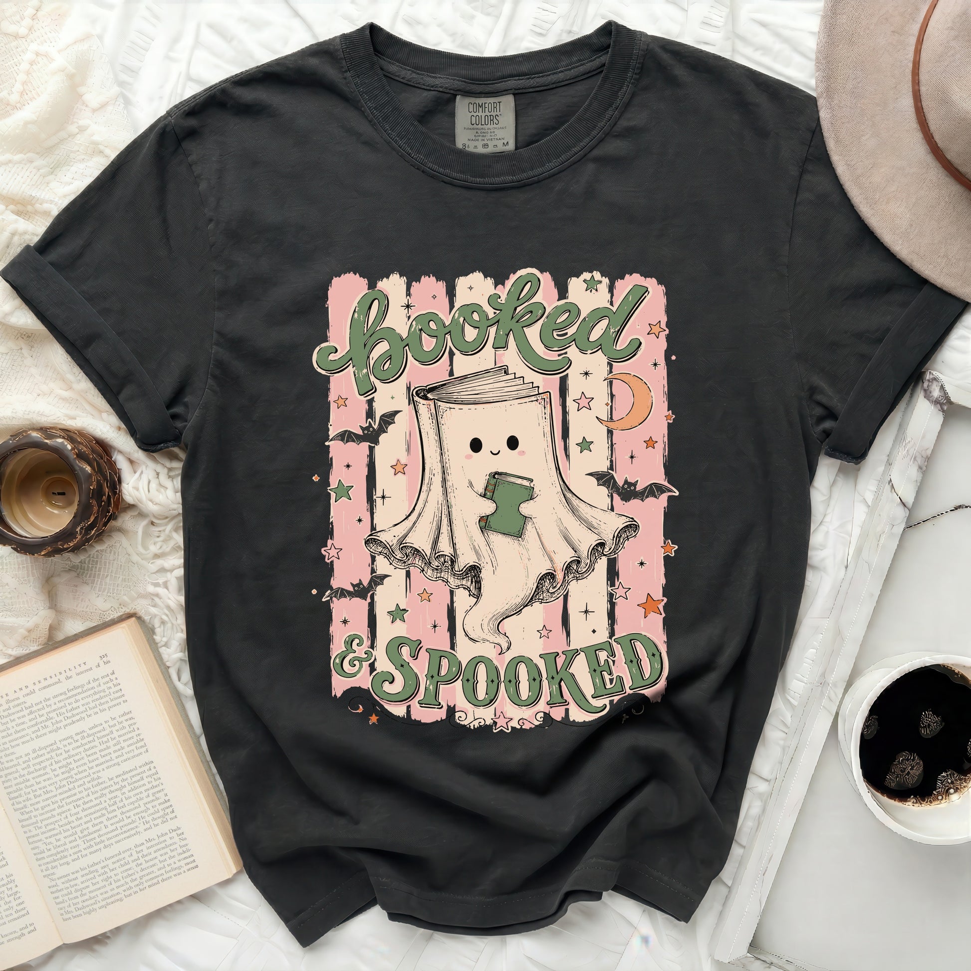 Booked & Spooked graphic tee with ghost reading a book, bats, and moon.