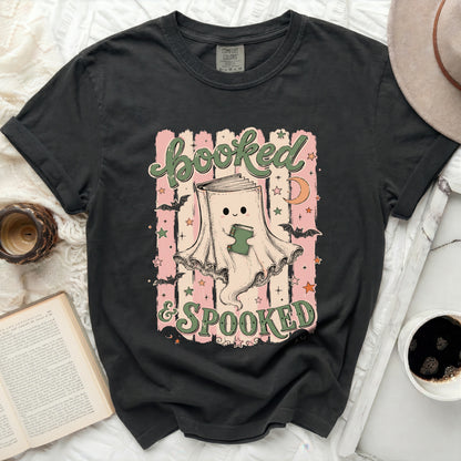 Booked & Spooked graphic tee with ghost reading a book, bats, and moon.