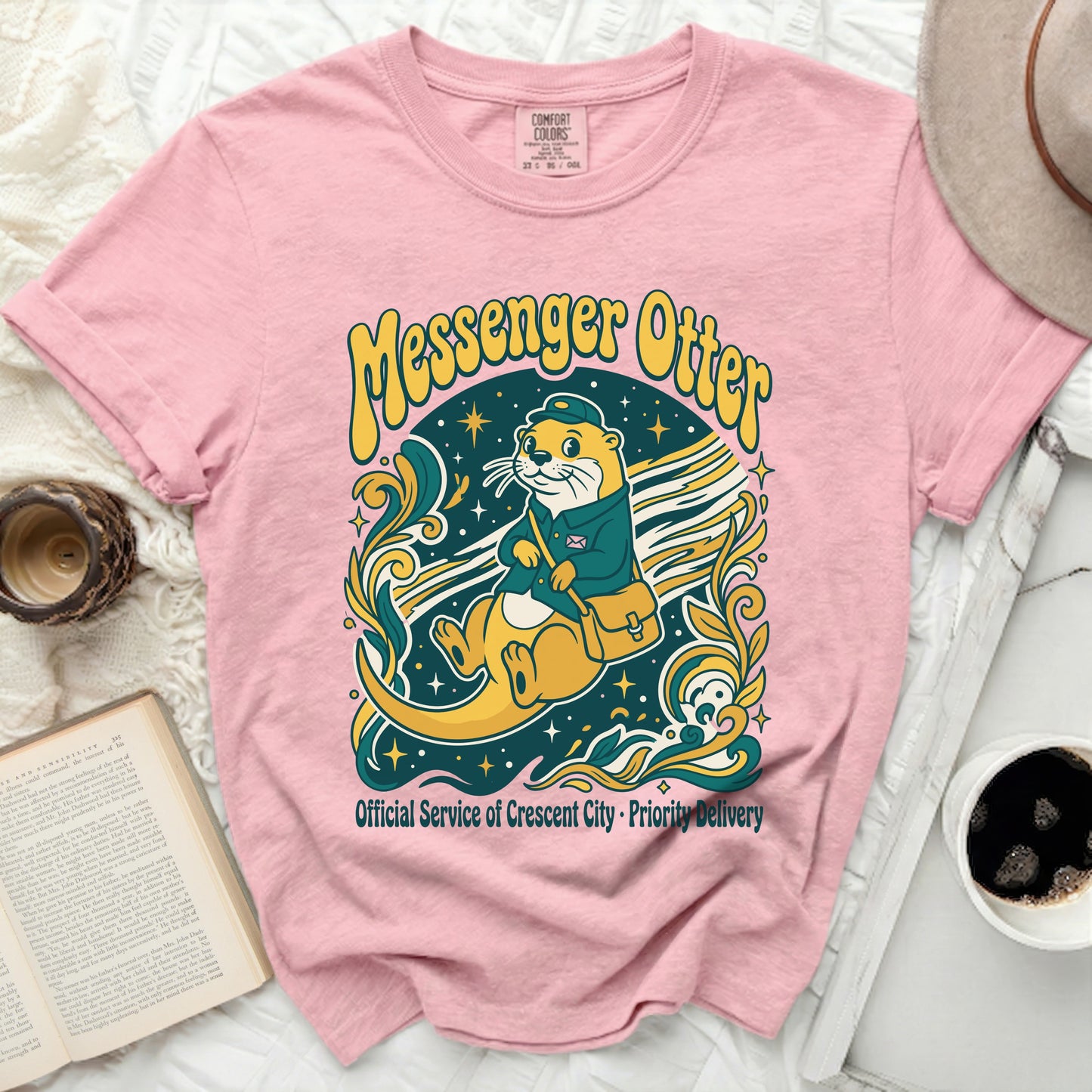 Pink t-shirt with a Messenger Otter graphic and text.