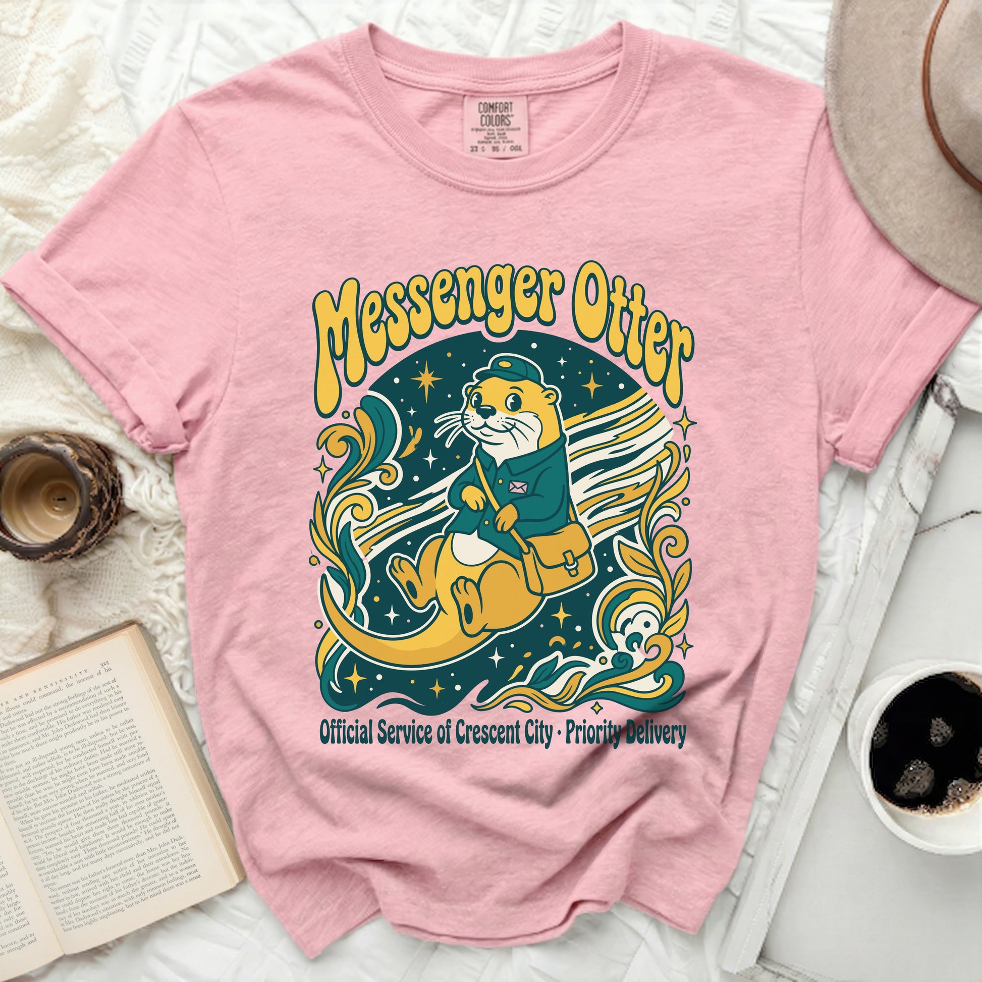 Pink t-shirt with a Messenger Otter graphic and text.