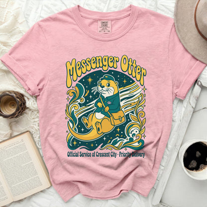 Pink t-shirt with a Messenger Otter graphic and text.