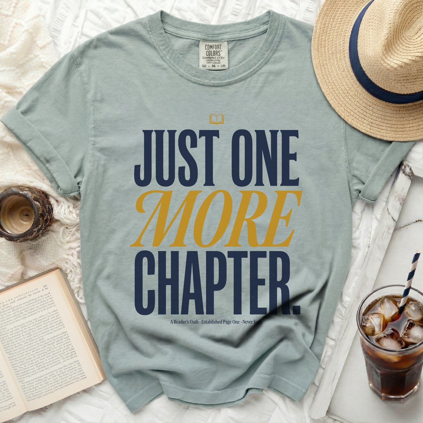 T-shirt with "JUST ONE MORE CHAPTER" in large text.