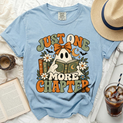 Light blue t-shirt with ghost reading a book graphic and "Just One More Chapter" text.