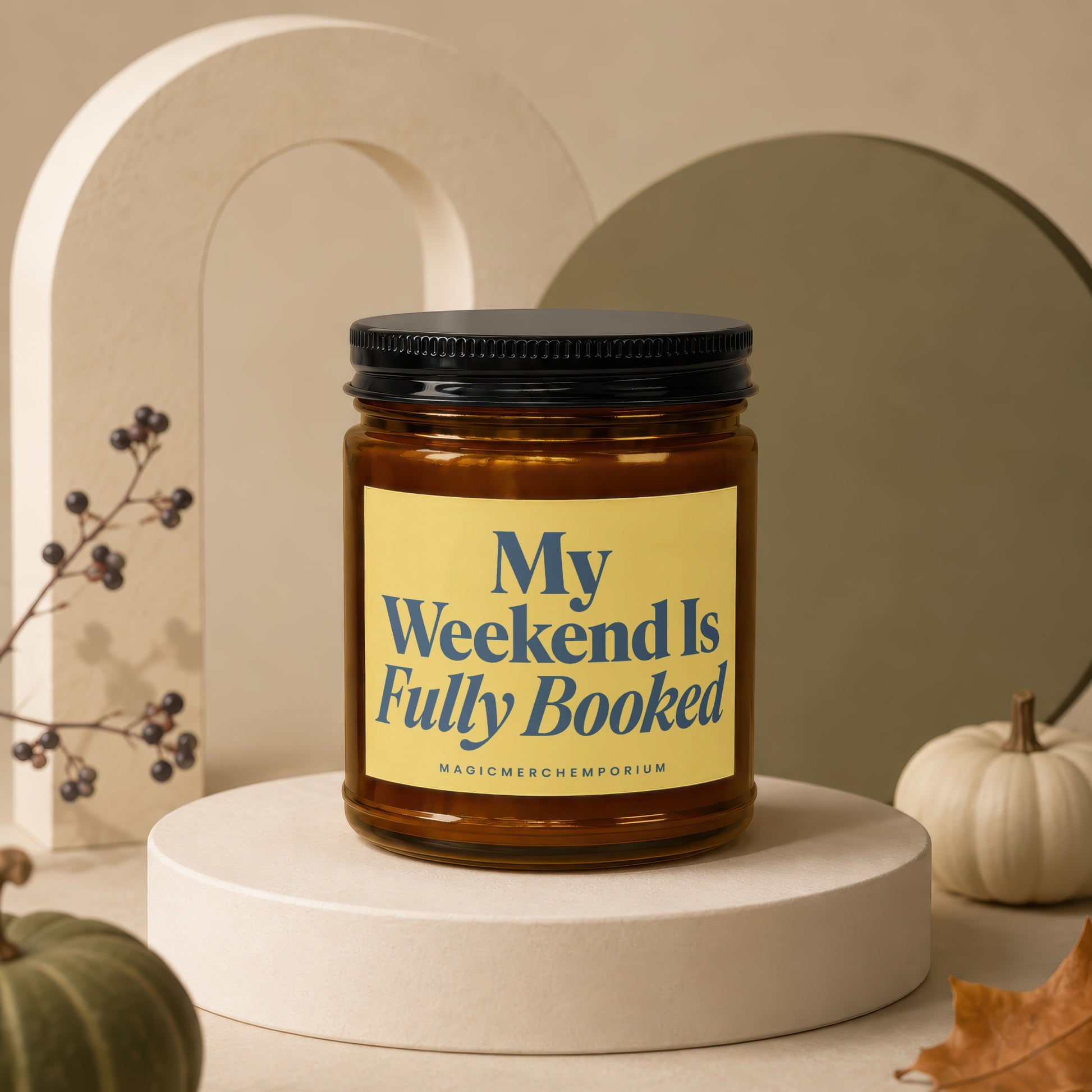 Brown glass candle with black lid and yellow label reading "My Weekend Is Fully Booked".