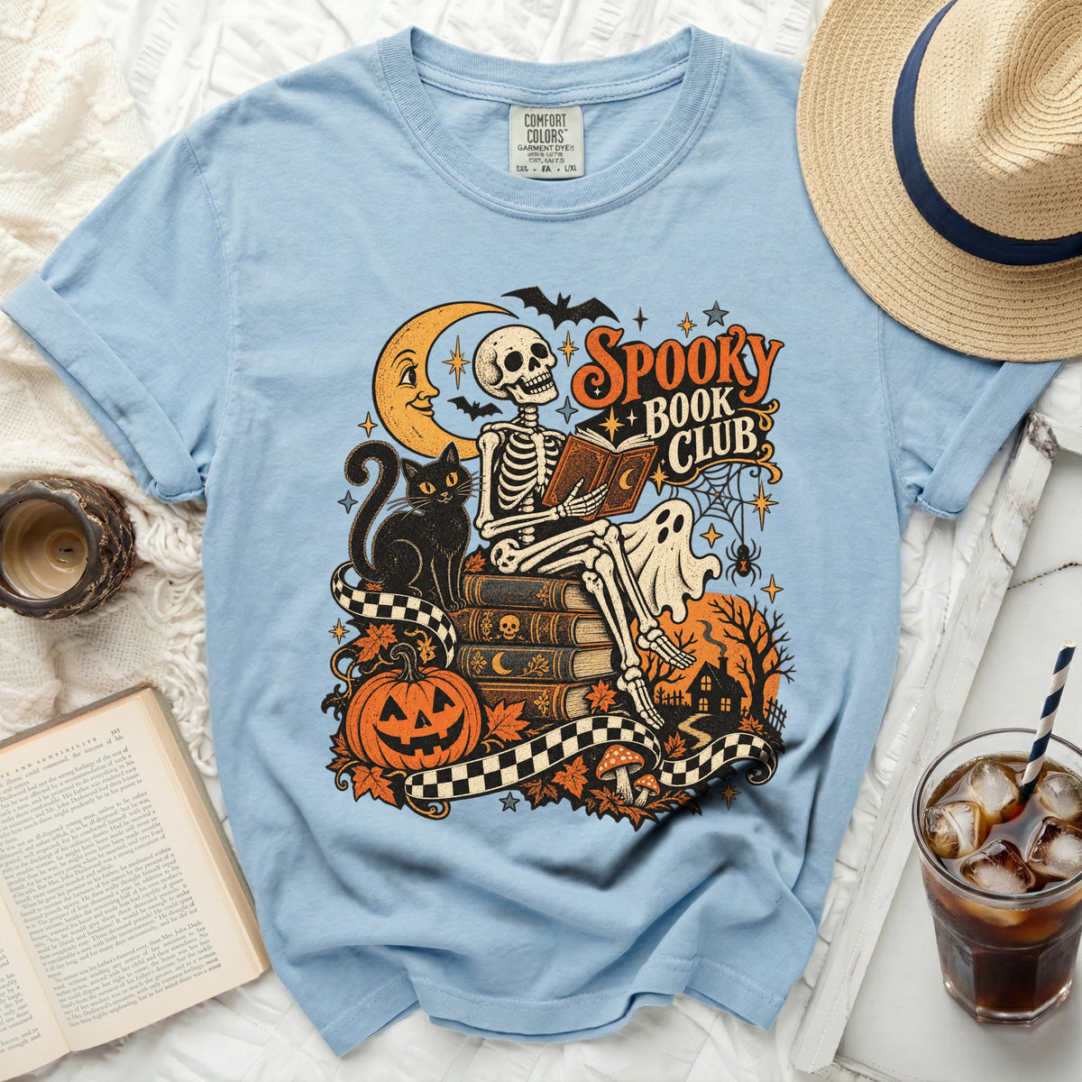Light blue t-shirt with "Spooky Book Club" graphic featuring a skeleton reading.