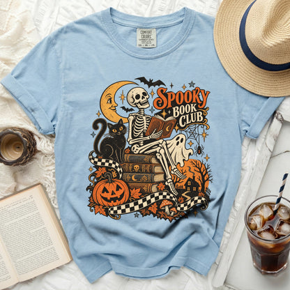 Light blue t-shirt with "Spooky Book Club" graphic featuring a skeleton reading.