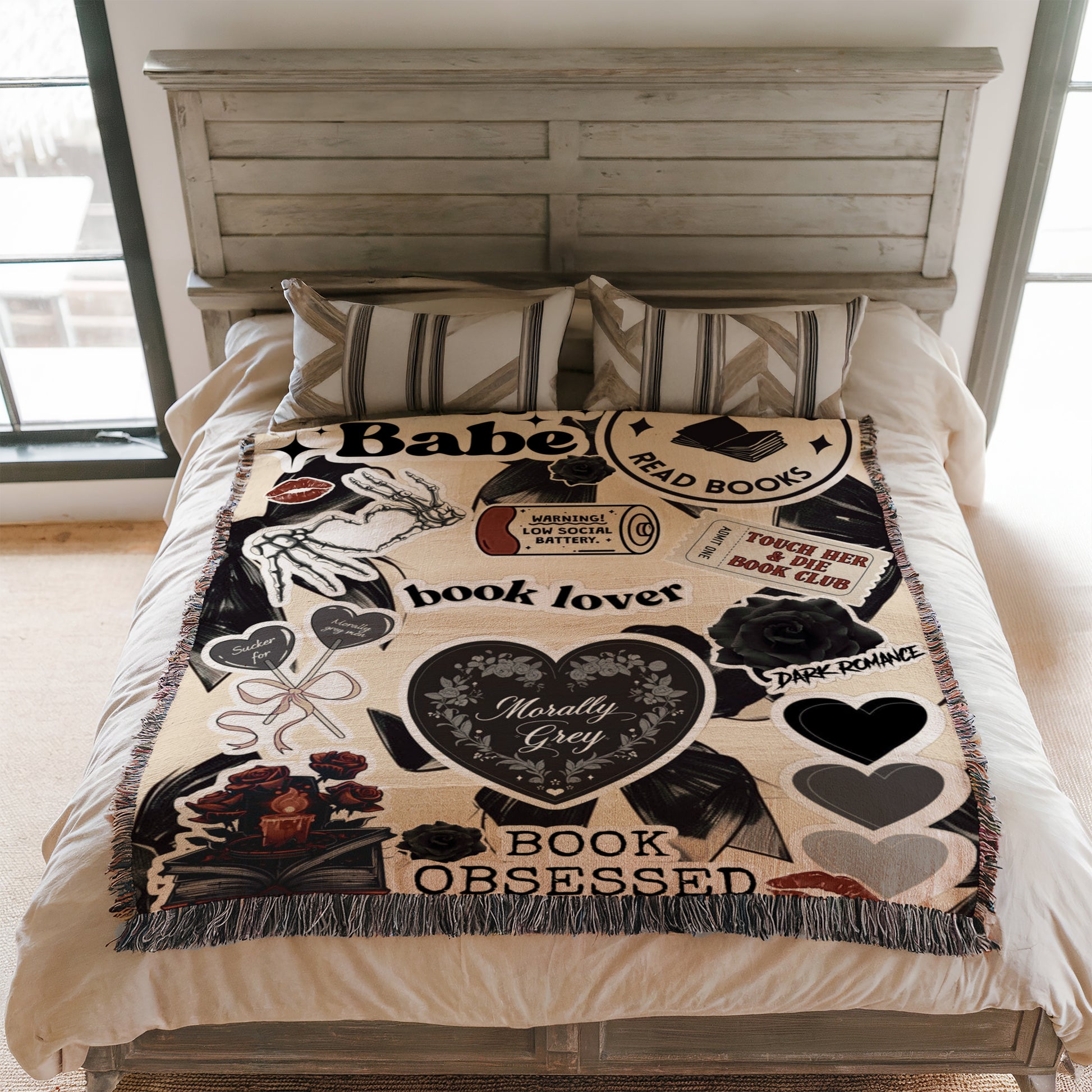 a bed with a blanket that has various text and images printed on it, including phrases like "Book lover", "Dark Romance", and "Book Obsessed".