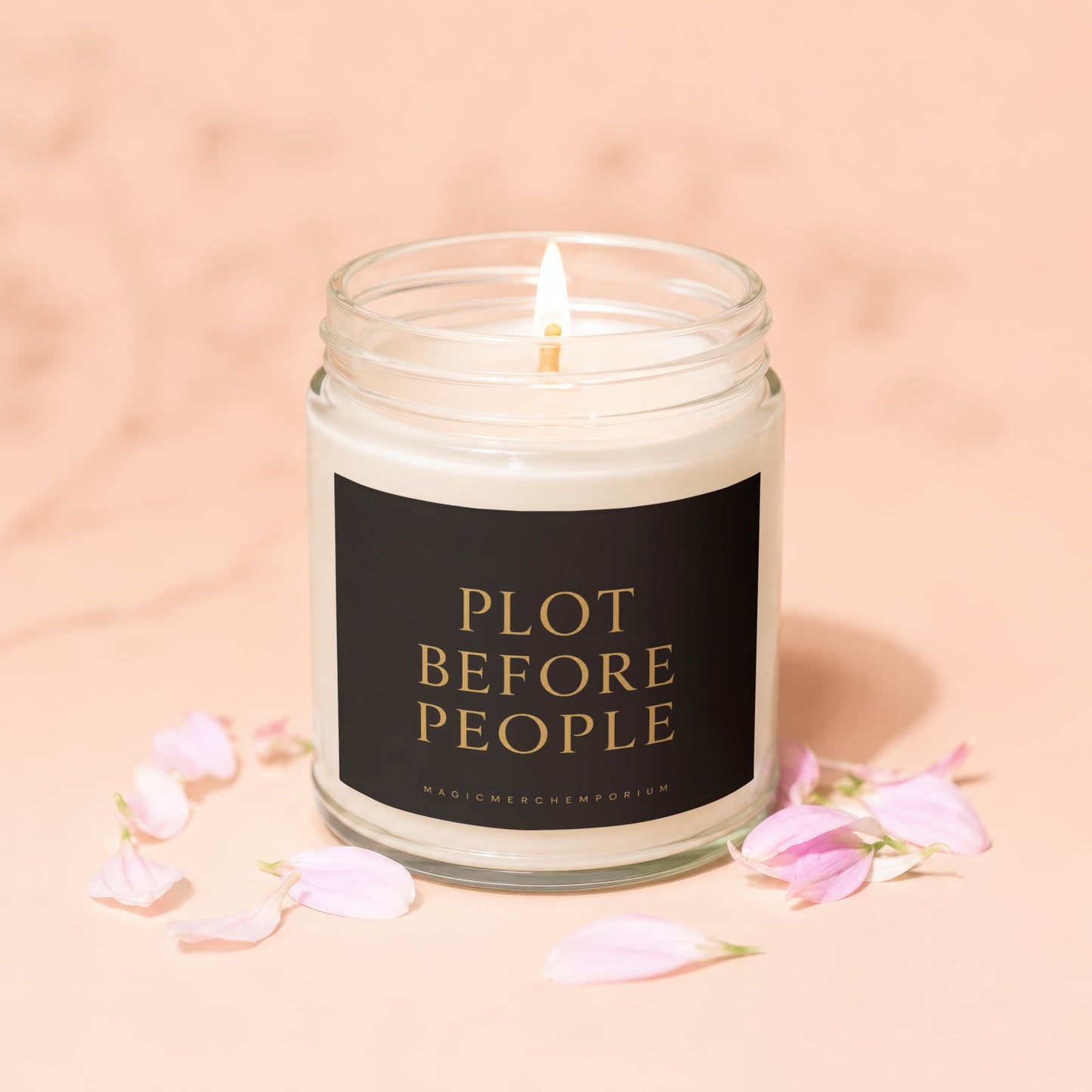 Lit candle with text "PLOT BEFORE PEOPLE" and "MAGICMERCHEMPORIUM" on a black label.