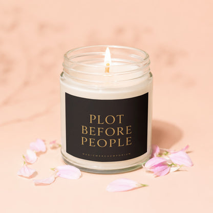 Lit candle with text "PLOT BEFORE PEOPLE" and "MAGICMERCHEMPORIUM" on a black label.