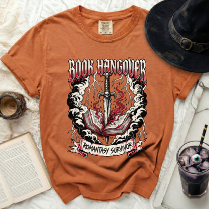 Orange t-shirt with "Book Hangover Romantasy Survivor" graphic.