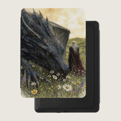 Dragon and figure with white hair in a field of flowers next to a black e-reader case.