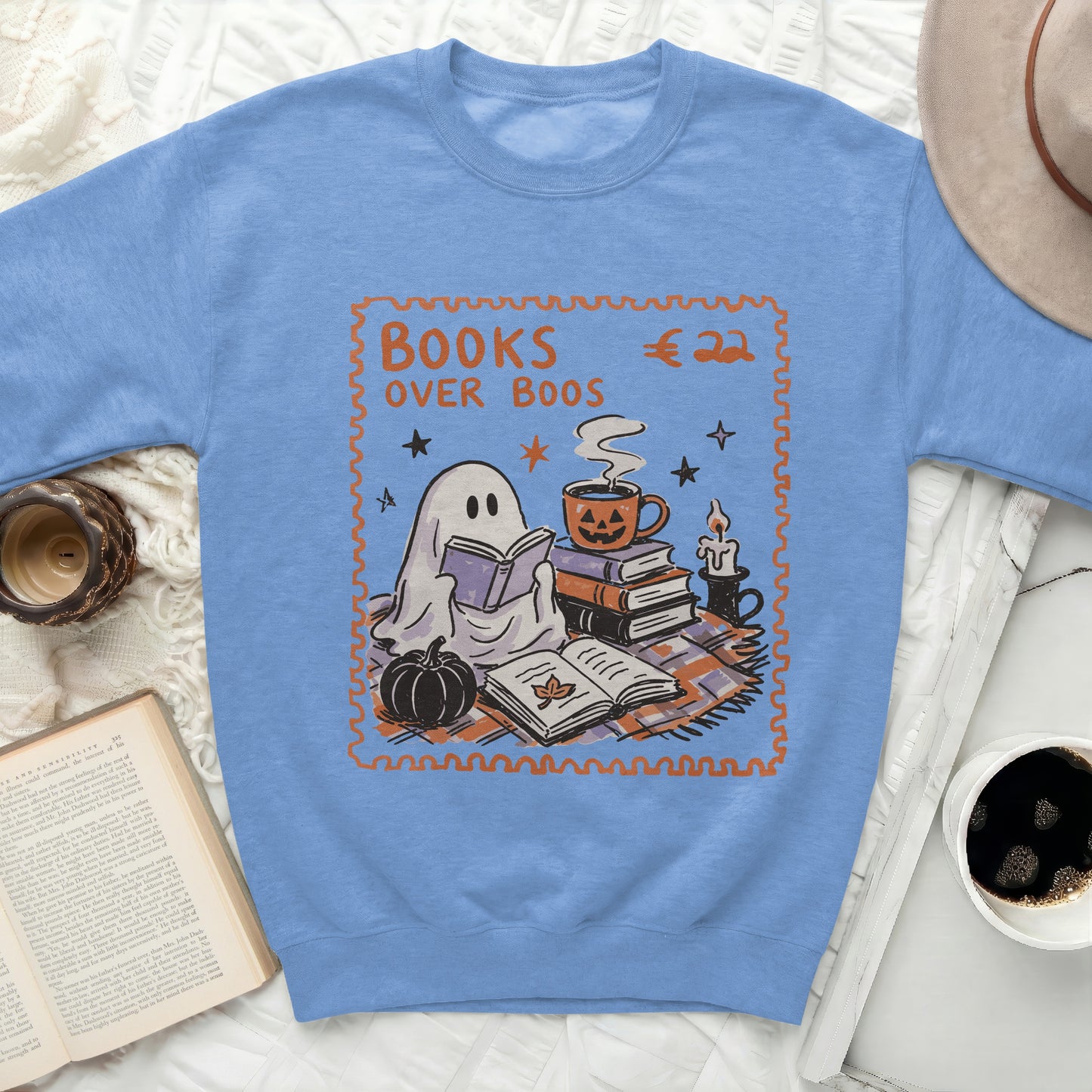 Sweatshirt with "Books over Boos" design featuring a ghost, pumpkin, and books.