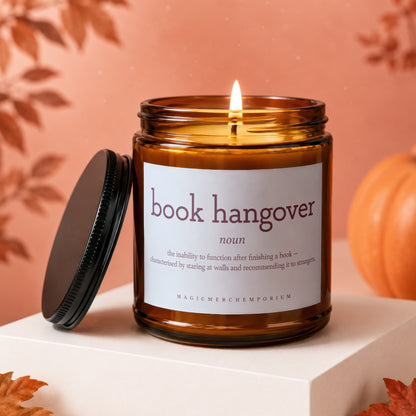 Amber candle with "book hangover" definition and Magic Merch Emporium logo.