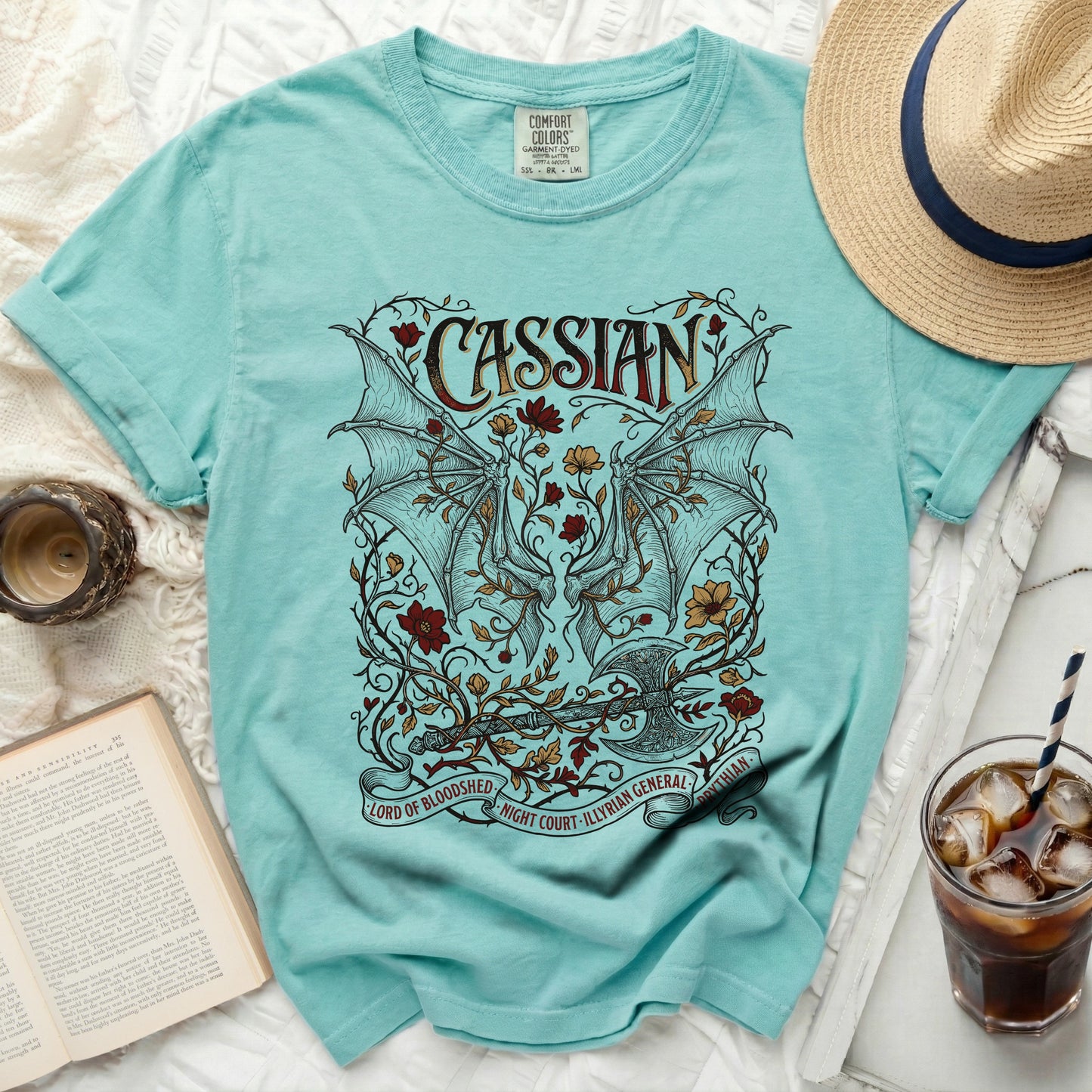 Cassian t-shirt with dragon wings, axe, flowers, and text.