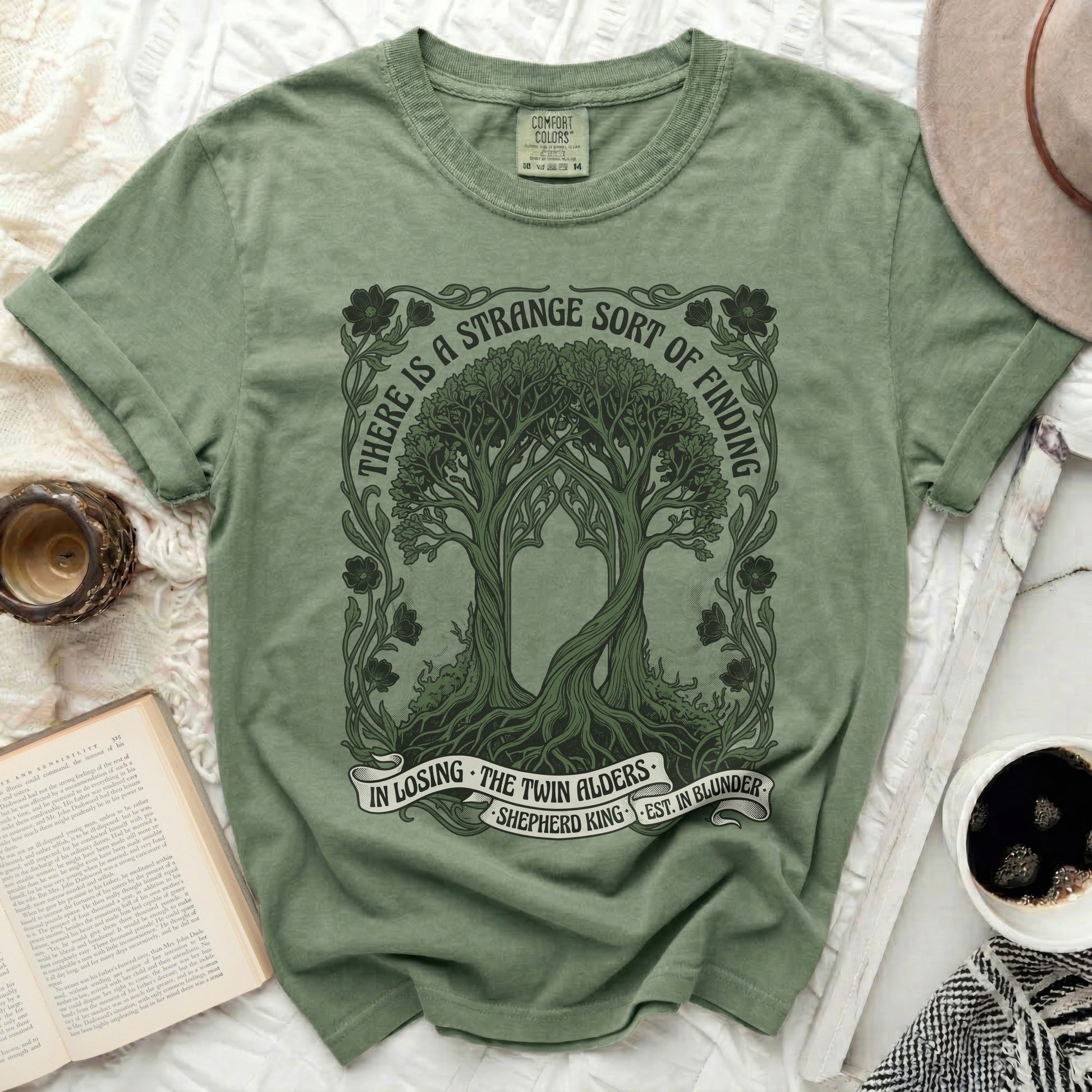 Green t-shirt with a circular nature design and text.