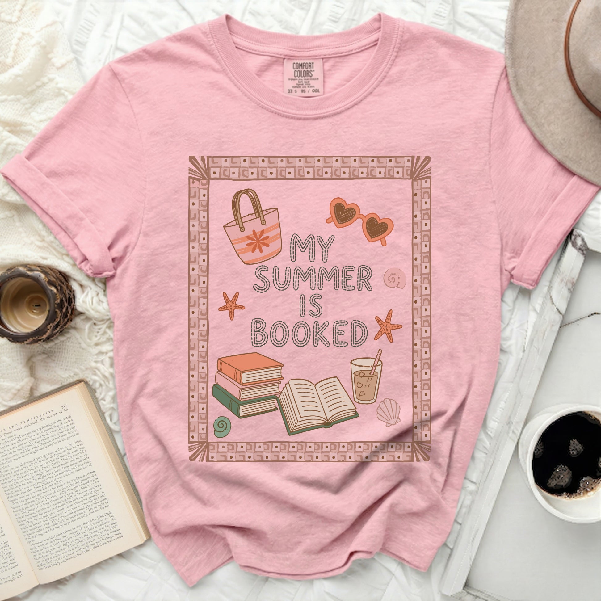 Pink t-shirt with "My Summer is Booked" and beach graphics.