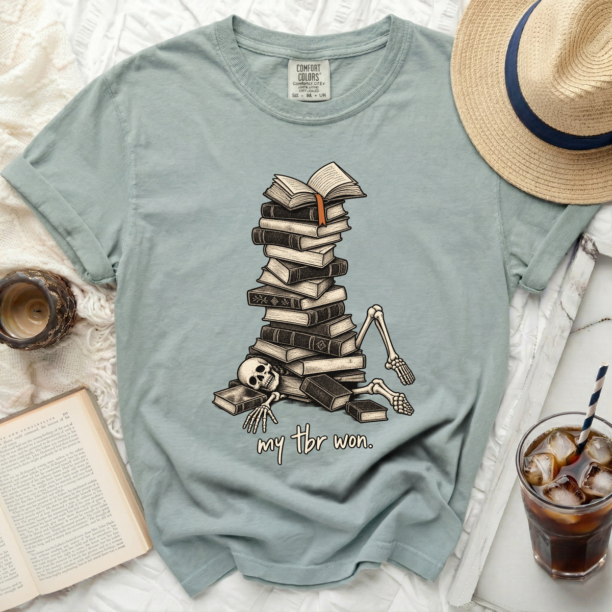 Skeleton buried under a pile of books with text "my tbr won"