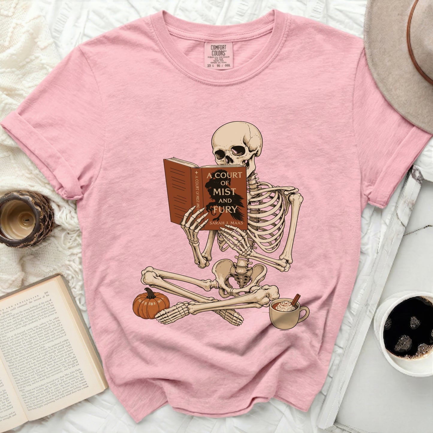 Skeleton reading "A Court of Mist and Fury" by Sarah J. Maas.