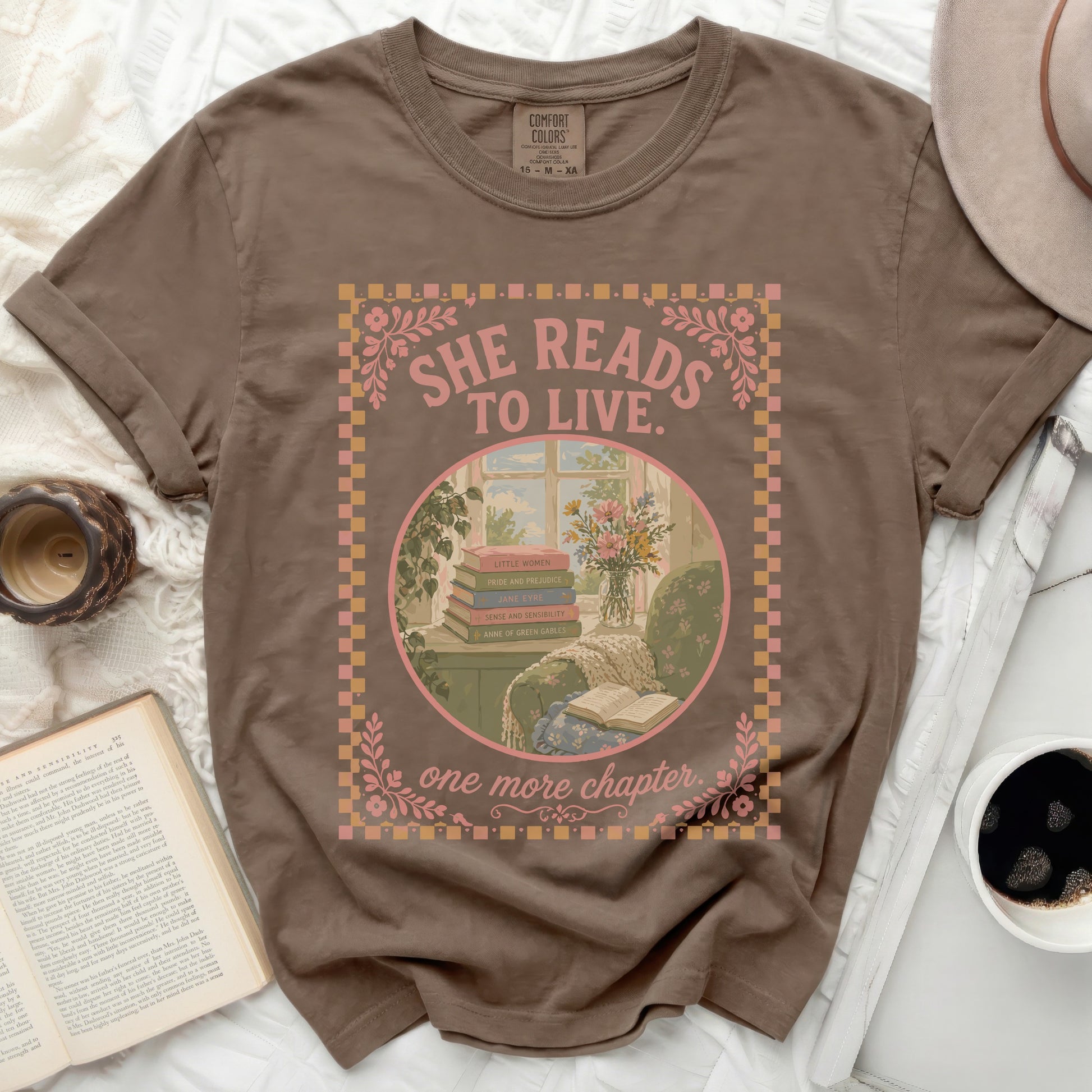Brown t-shirt with "She Reads To Live. One More Chapter." book graphic.