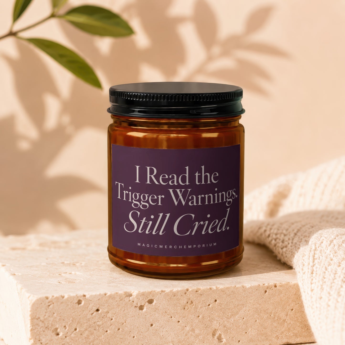 Amber jar candle with a purple label reading "I Read the Trigger Warnings. Still Cried."