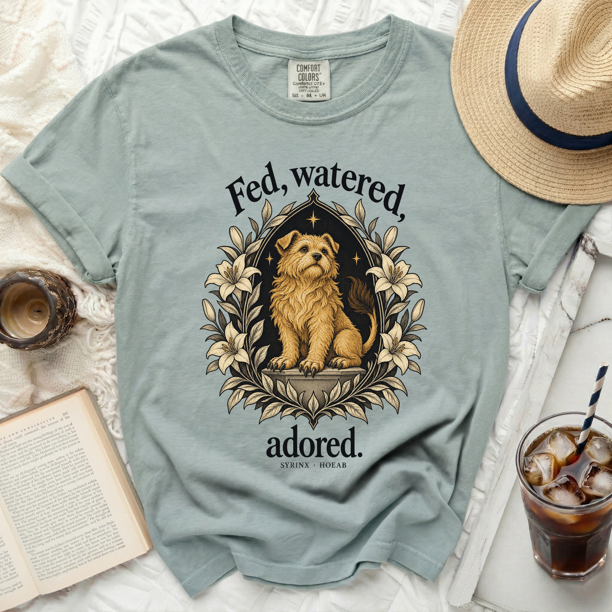 Light blue t-shirt with dog graphic and text "Fed, watered, adored."