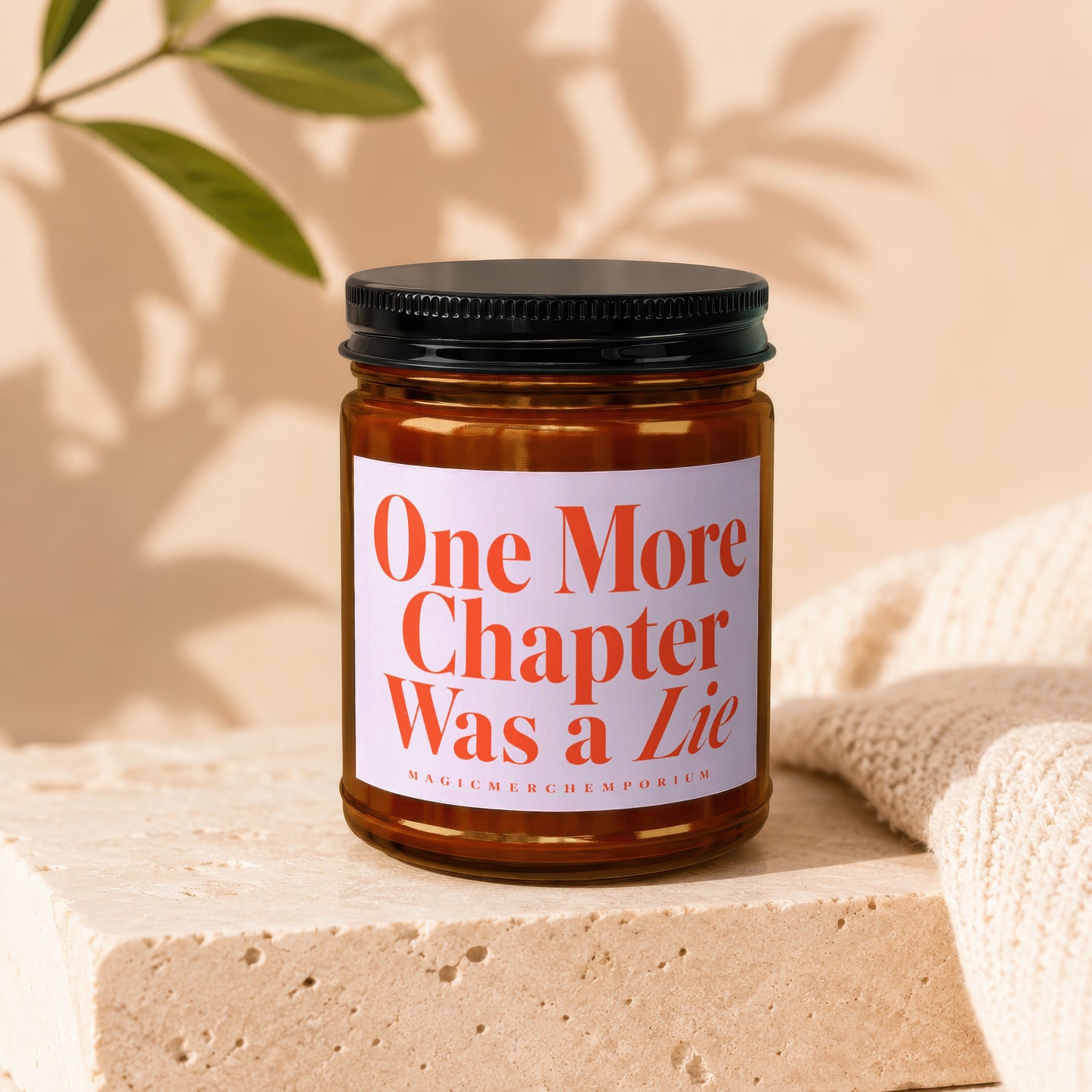 Amber jar candle with white label reading "One More Chapter Was a Lie".