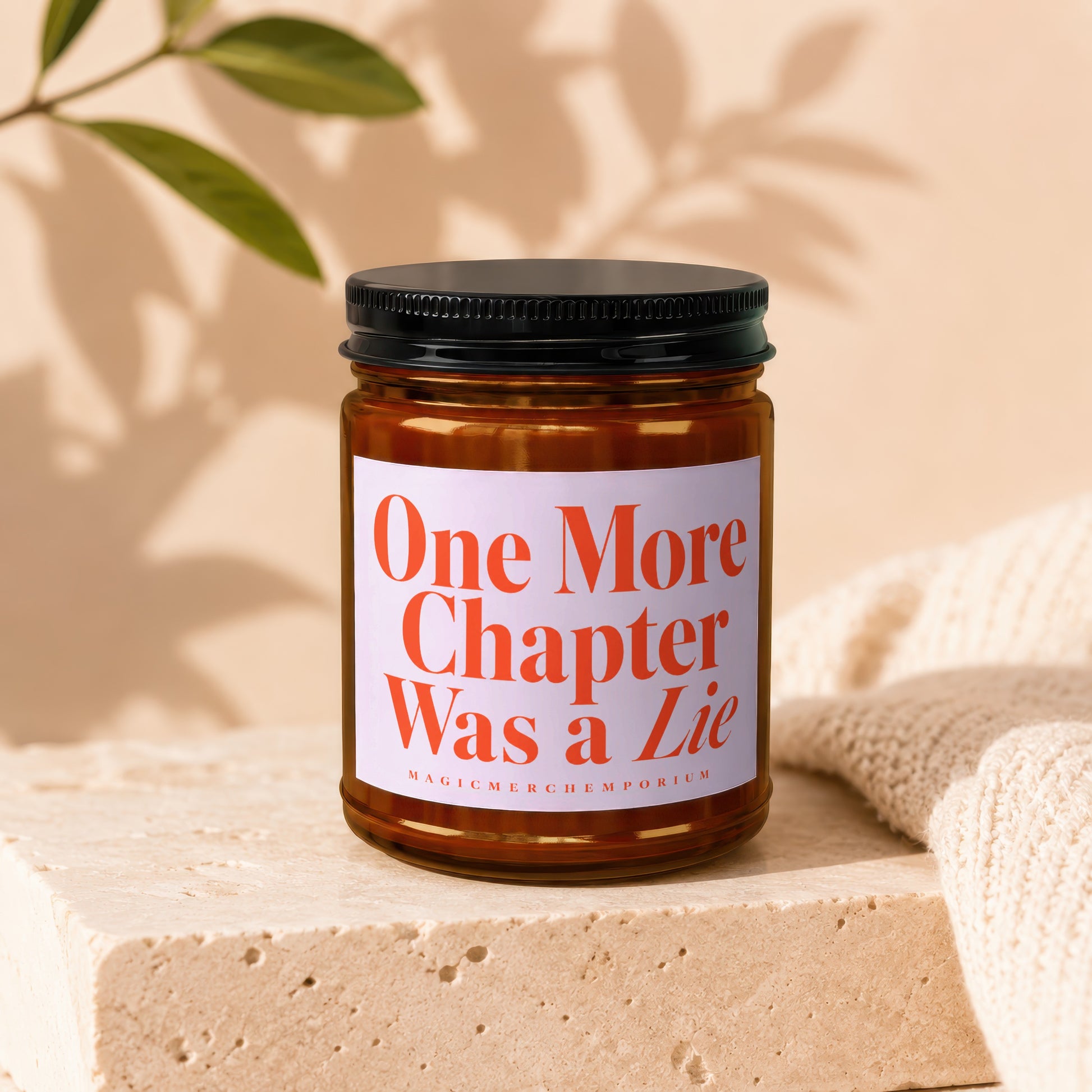 Amber jar candle with white label reading "One More Chapter Was a Lie".