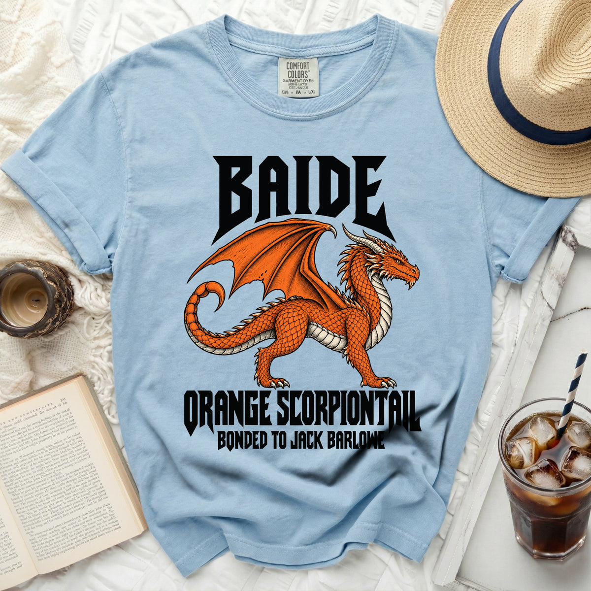 Light blue t-shirt with black text "BAIDE ORANGE SCORPIONTAIL BONDED TO JACK BARLOWE" and an orange dragon graphic.