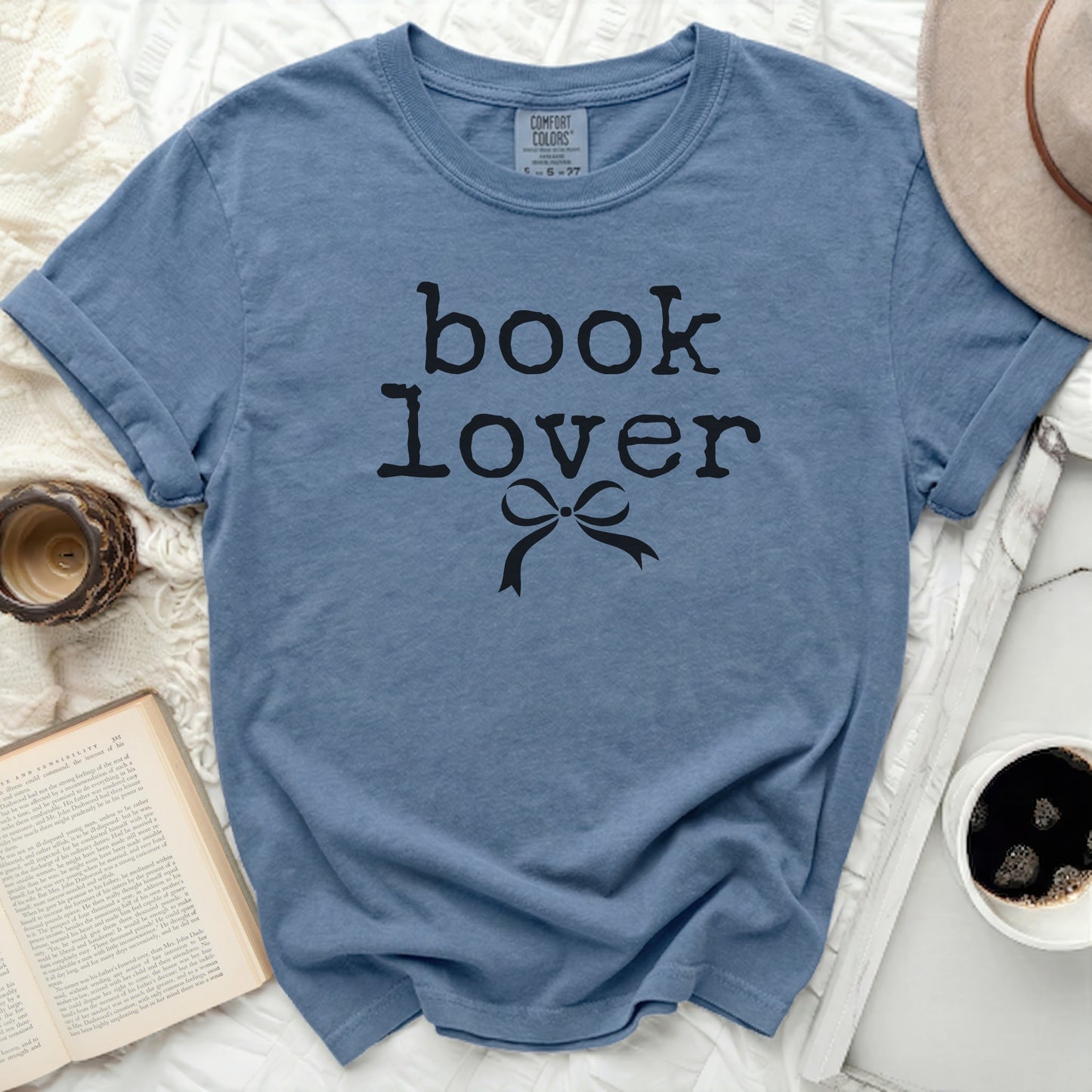 Blue t-shirt with black "book lover" text and a bow.