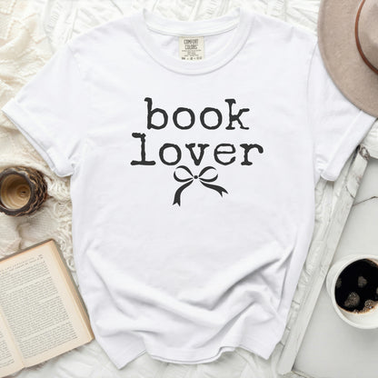 White t-shirt with black "book lover" text and bow graphic.