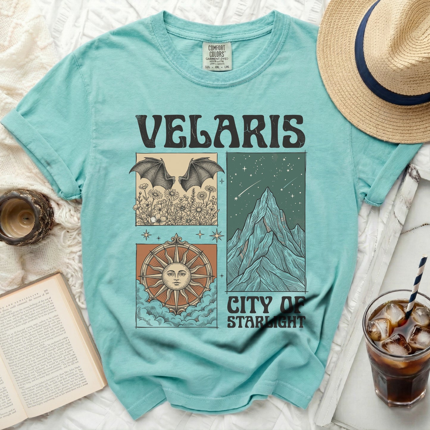 Teal t-shirt with "Velaris City of Starlight" graphic featuring bats, mountains, and a sun compass.