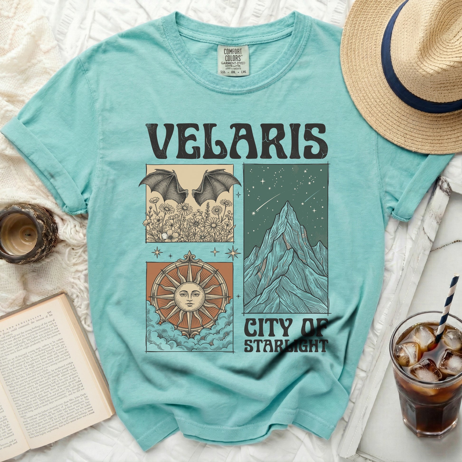 Teal t-shirt with "Velaris City of Starlight" graphic featuring bats, mountains, and a sun compass.