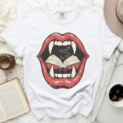 Graphic of red lips with fangs, open book, and bats on a white t-shirt.