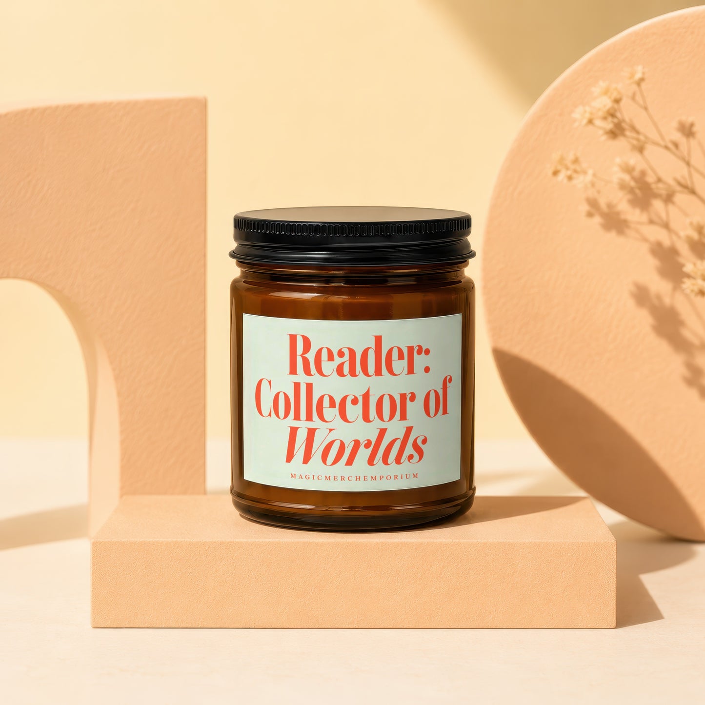 Amber jar candle with "Reader: Collector of Worlds" text on a light green label.