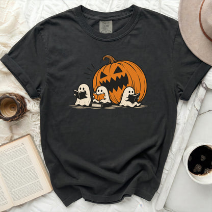 Dark t-shirt with a Halloween graphic of a pumpkin and three reading ghosts.