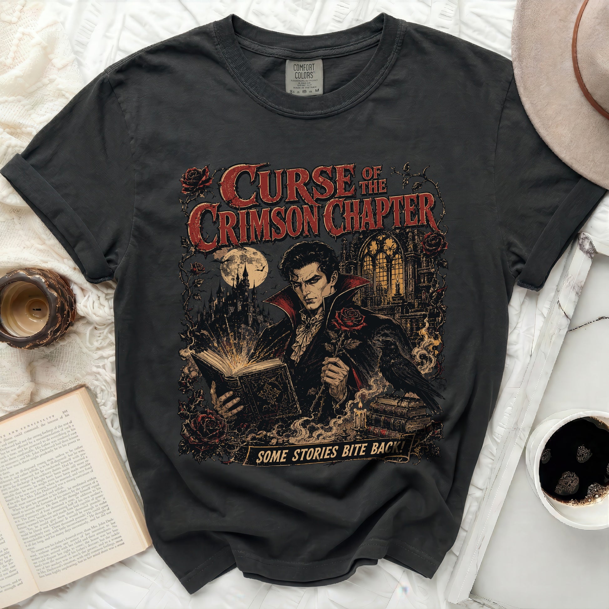Dark t-shirt with a vampire reading a book and "Curse of the Crimson Chapter"."},