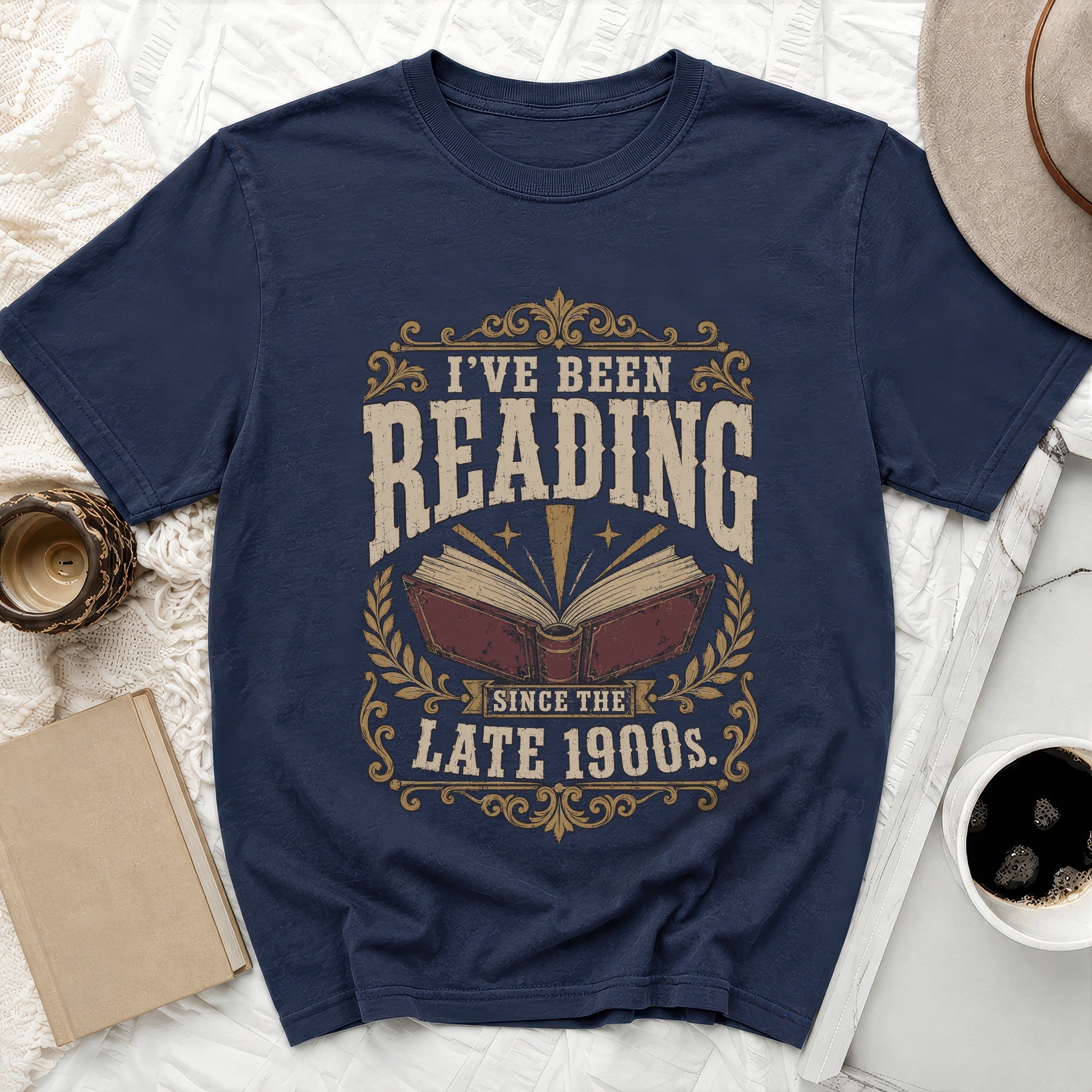 Navy t-shirt with "I've Been Reading Since the Late 1900s" text and open book graphic.