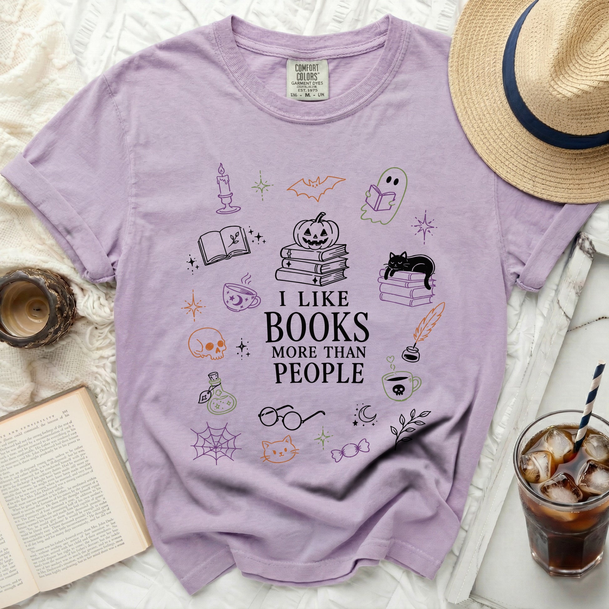 Purple t-shirt with "I like books more than people" text and doodles.