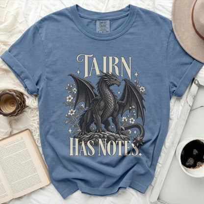 Blue t-shirt with a black dragon and flowers design, text "TAIRN HAS NOTES".