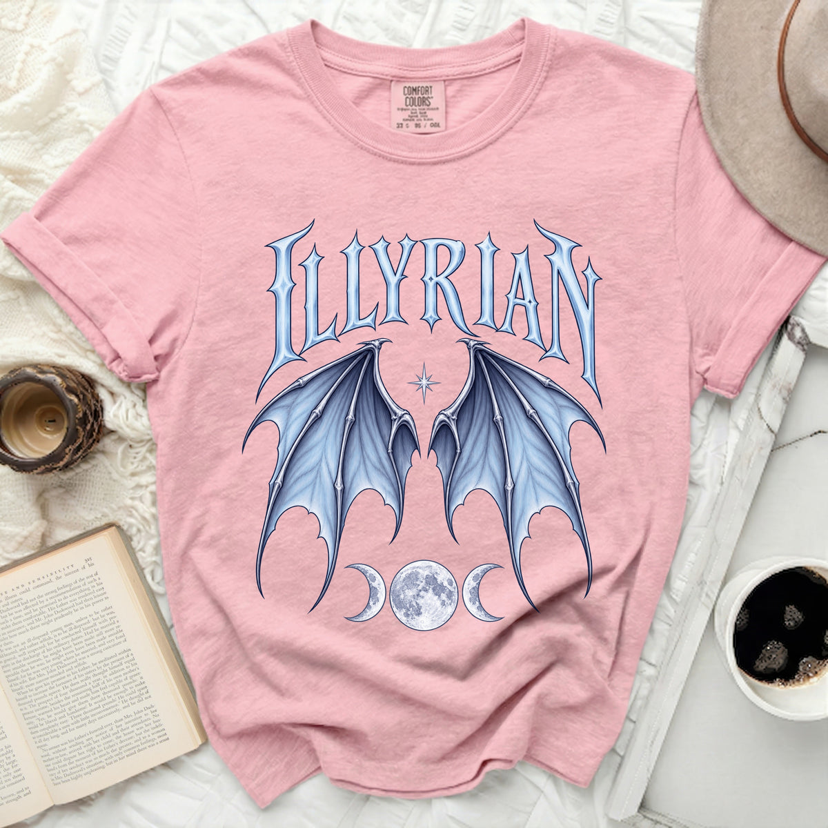 Pink t-shirt with "ILLYRIAN" text, blue bat wings, and triple moons.