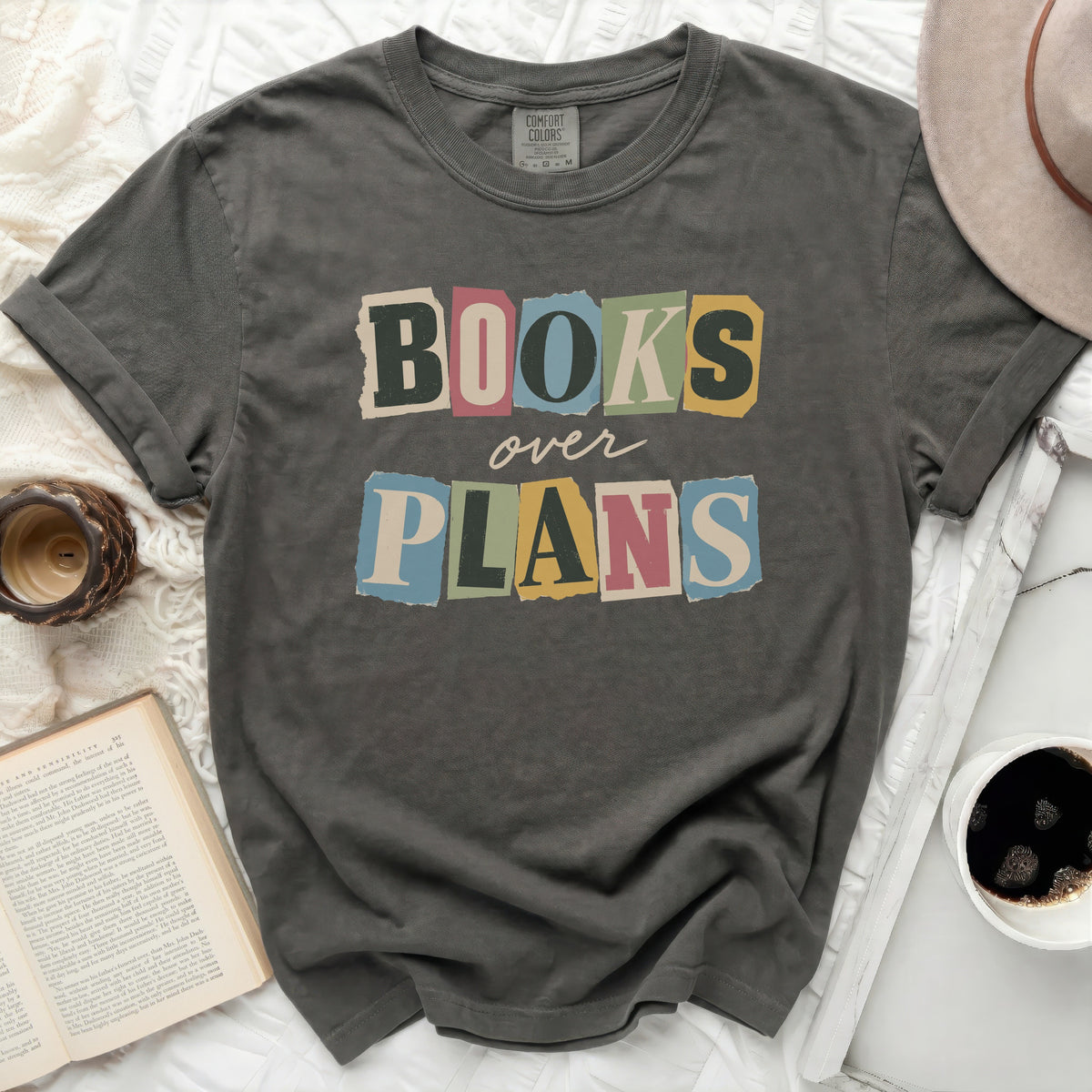 Charcoal grey Comfort Colors t-shirt with "BOOKS over PLANS" graphic.