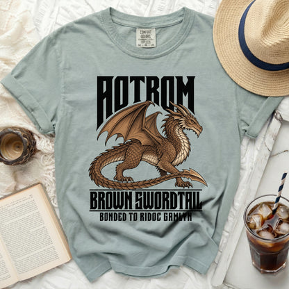 AOTROM brown dragon with swordtail graphic on a light blue t-shirt.