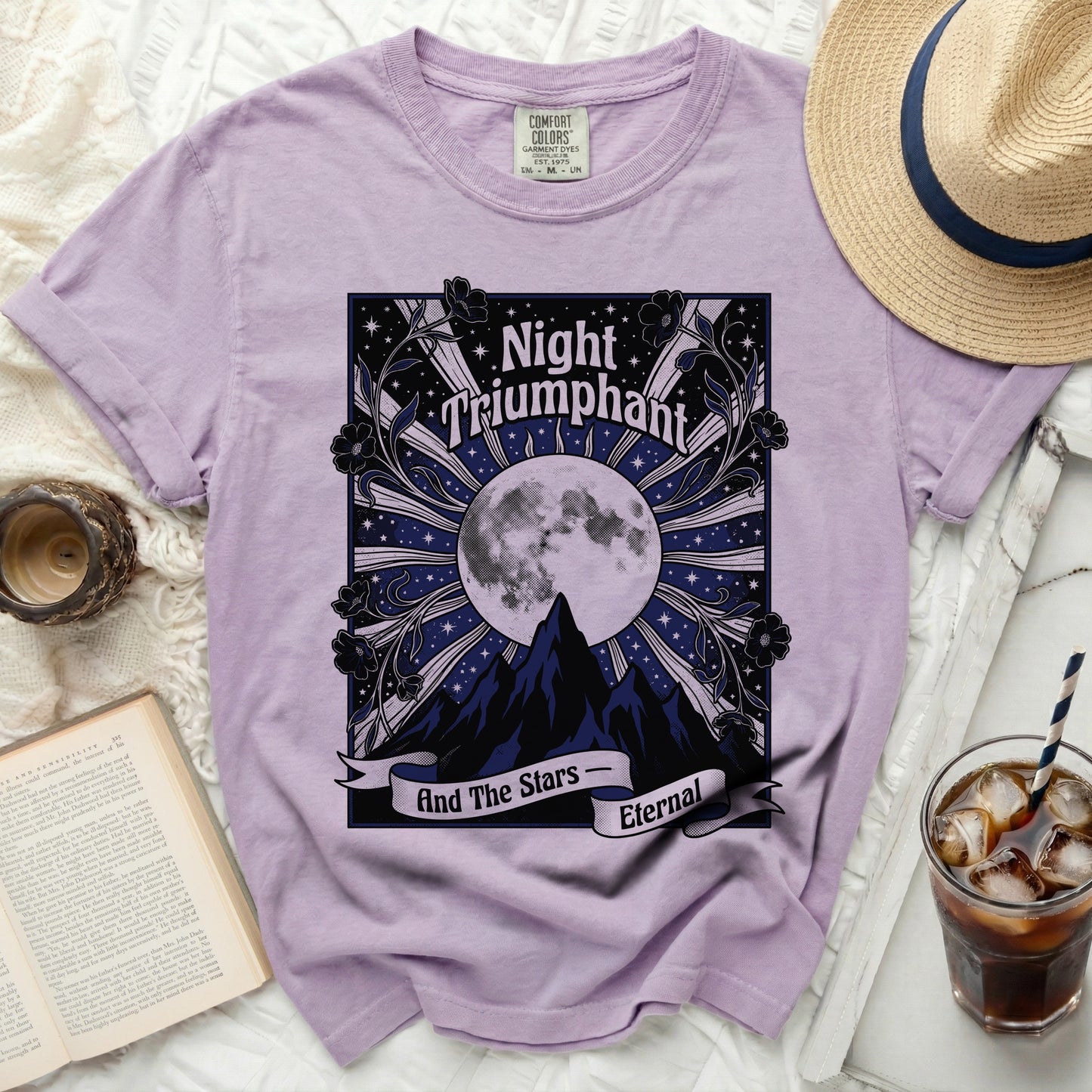 Purple t-shirt with "Night Triumphant And The Stars Eternal" moon and mountain graphic.