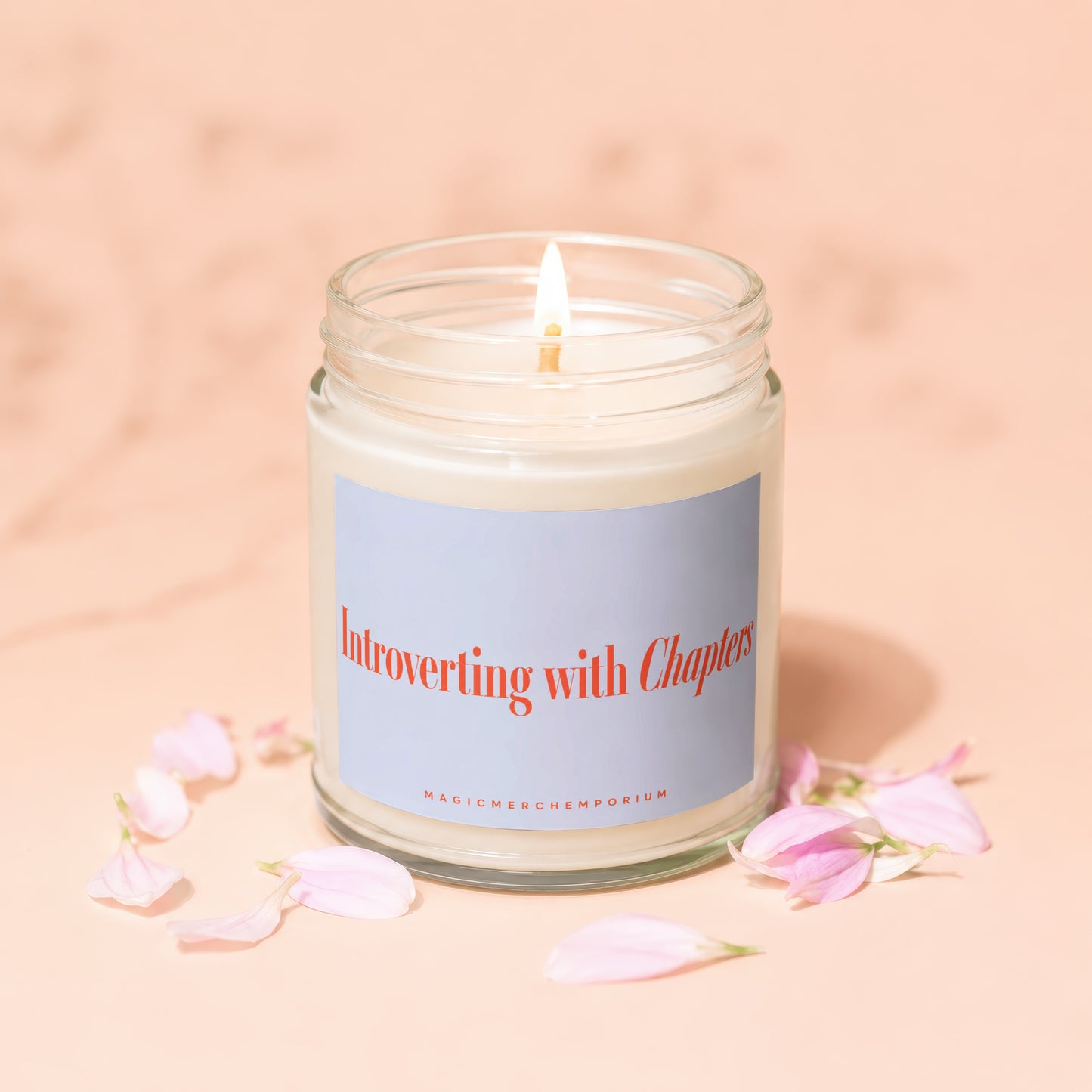 Lit candle in glass jar with label stating "Introverting with Chapters"