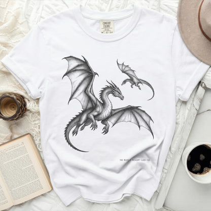 White t-shirt with graphite drawing of two dragons and text "YOU WANT A DRAGON? EARN ONE."