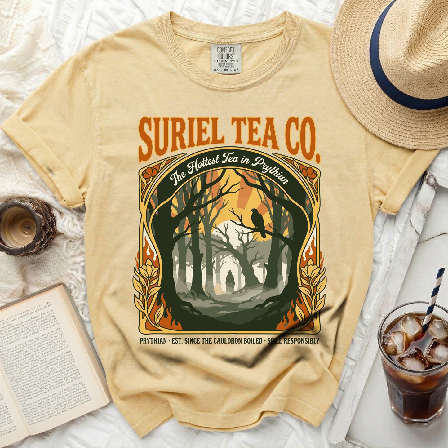 Yellow t-shirt with "Suriel Tea Co." and a forest graphic.