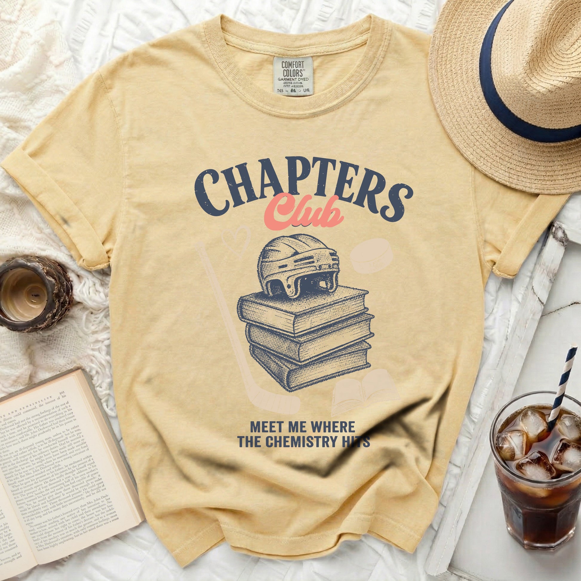 Yellow t-shirt with "Chapters Club" text and stack of books graphic.