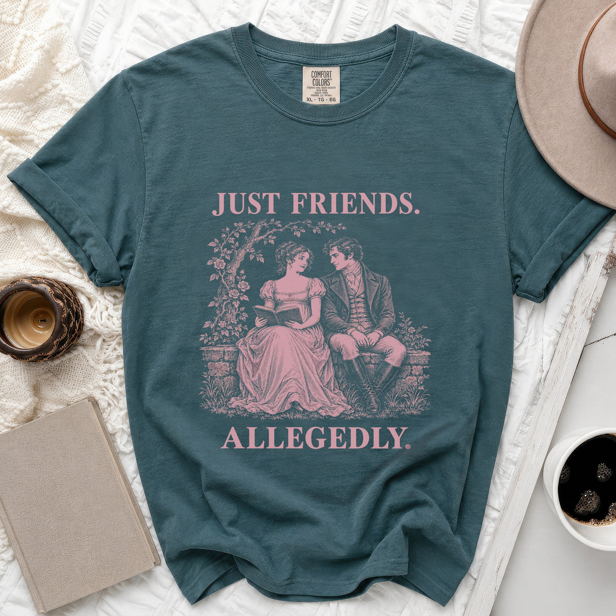 Teal t-shirt with pink text "JUST FRIENDS. ALLEGEDLY." and a vintage illustration.