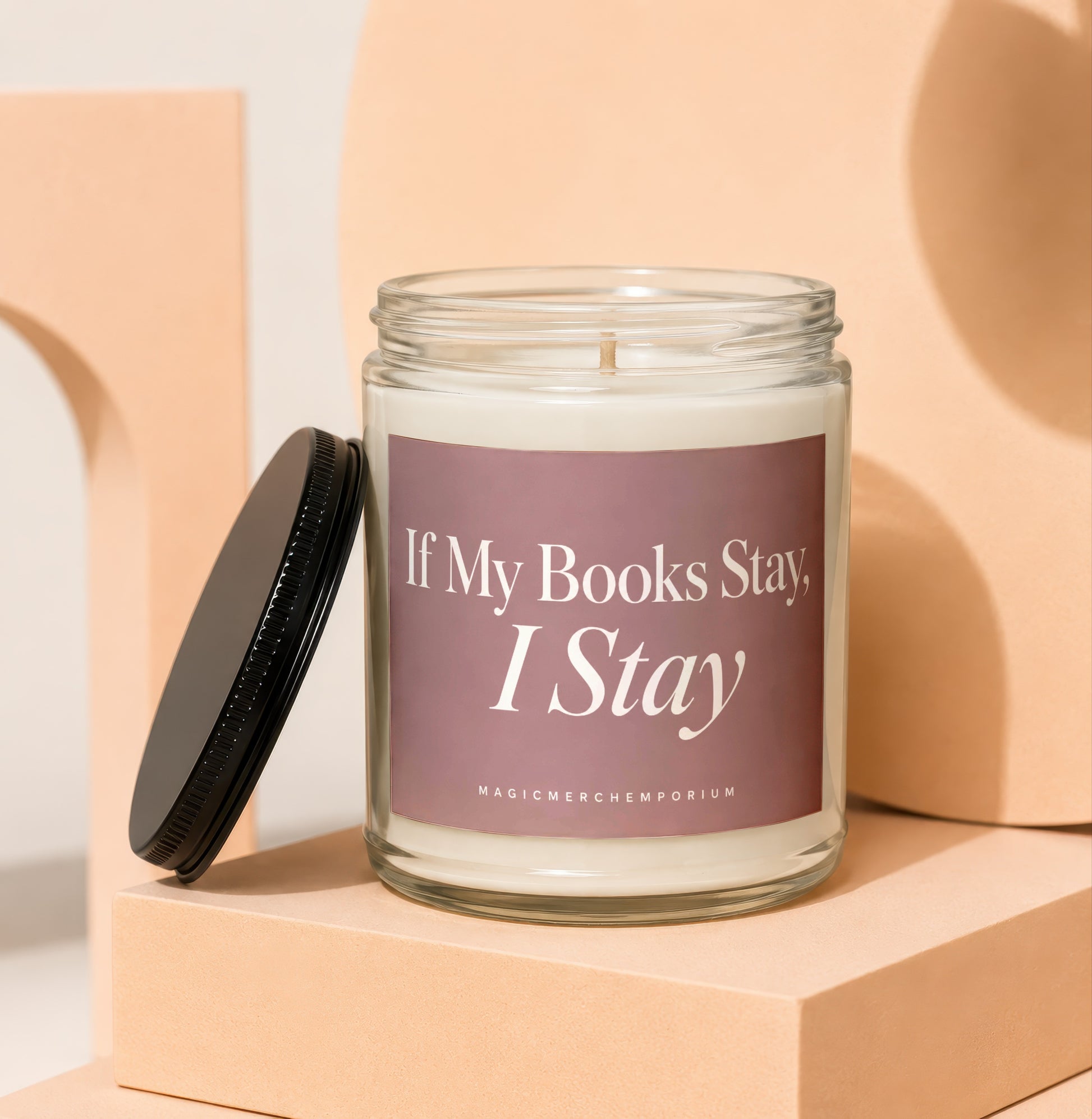 Glass jar candle with lid off, featuring text "If My Books Stay, I Stay".