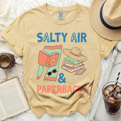 Yellow t-shirt with "Salty Air & Paperbacks" text and book graphics.